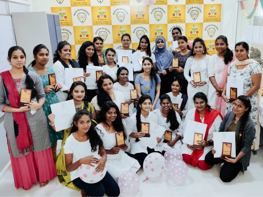 Students with certificates at the Institute of Cosmetic Science