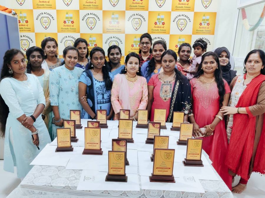 Students with trophies at the Institute of Cosmetic Science