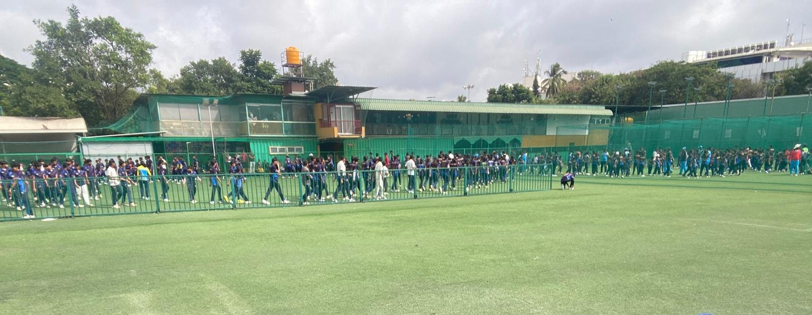 Players gathered at a cricket ground in India