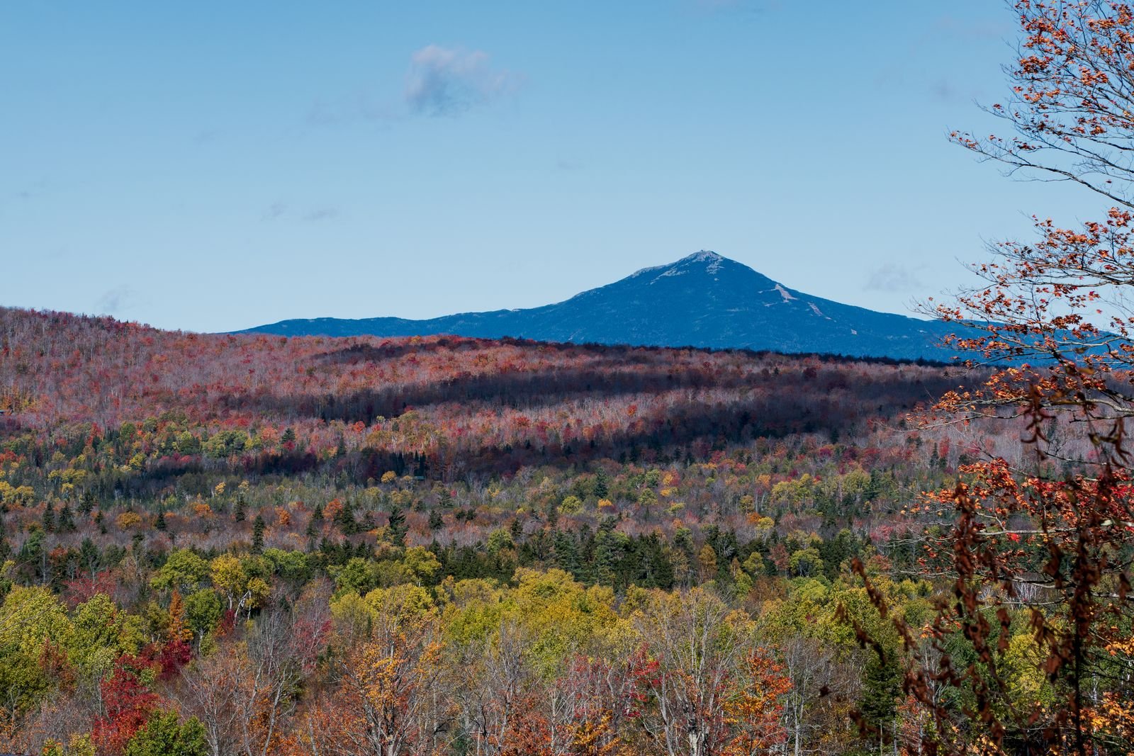 Autumn view of the Adirondack Mountains with colorful foliage and distant peaks