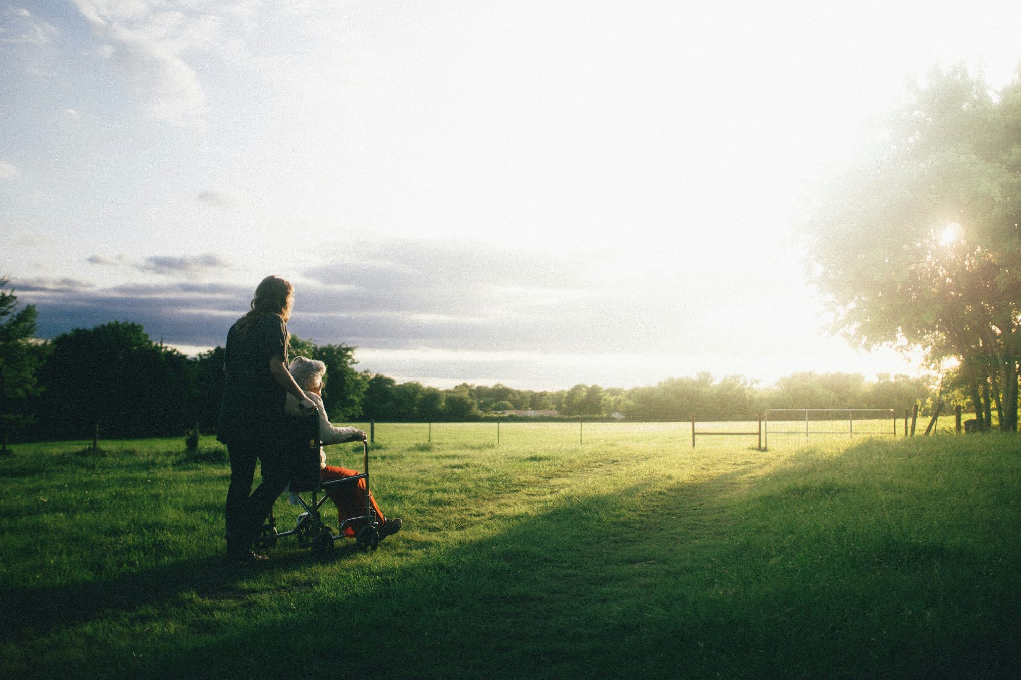 Caregiver walking beside a senior woman