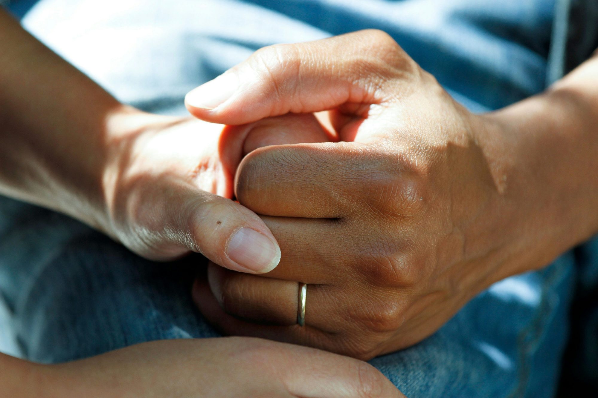 Caring hands holding a senior's hand