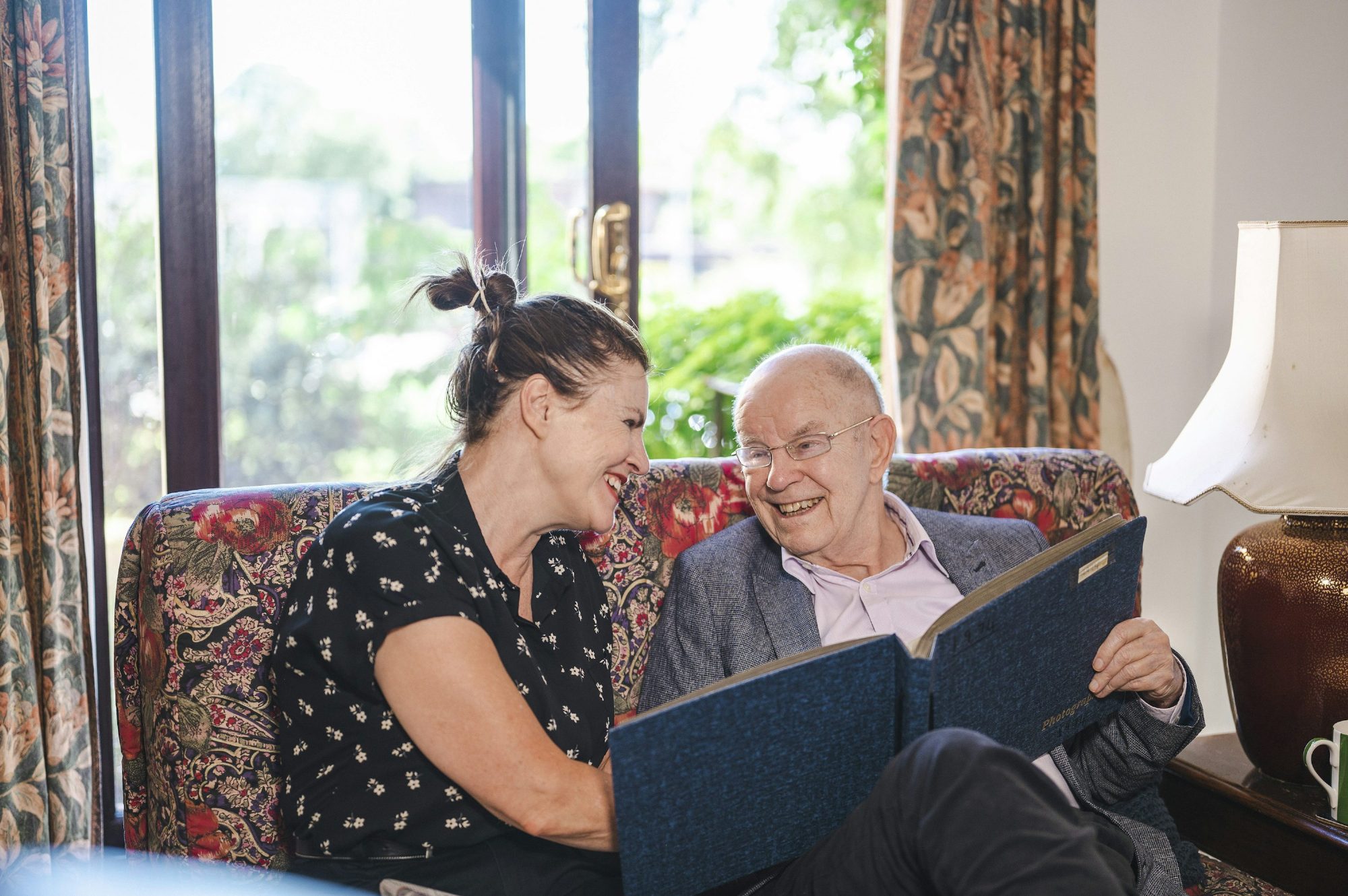 Caregiver sitting with a senior resident