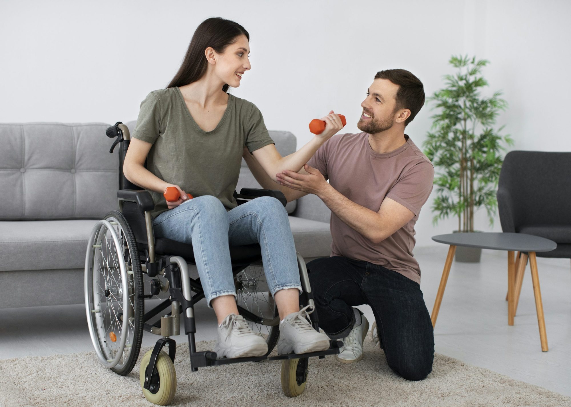 Senior woman doing light strength exercise with a therapist
