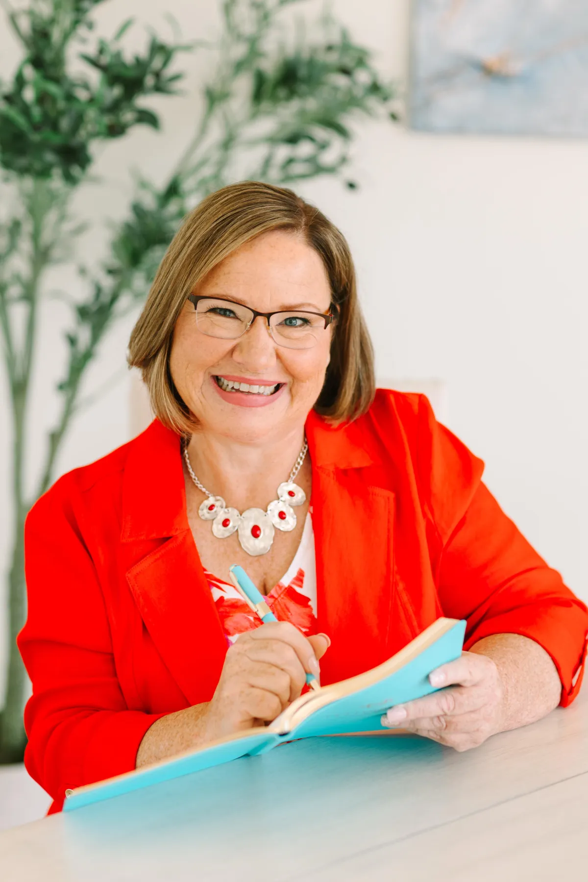 Laureen Shefchik holding her turquoise notebook