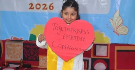 A child holding a heart reading togetherness, empathy, compassion
