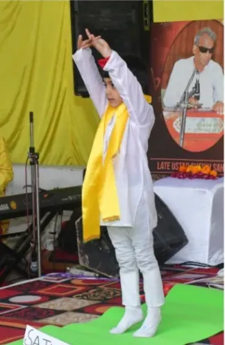 A child in a yoga pose at a school event