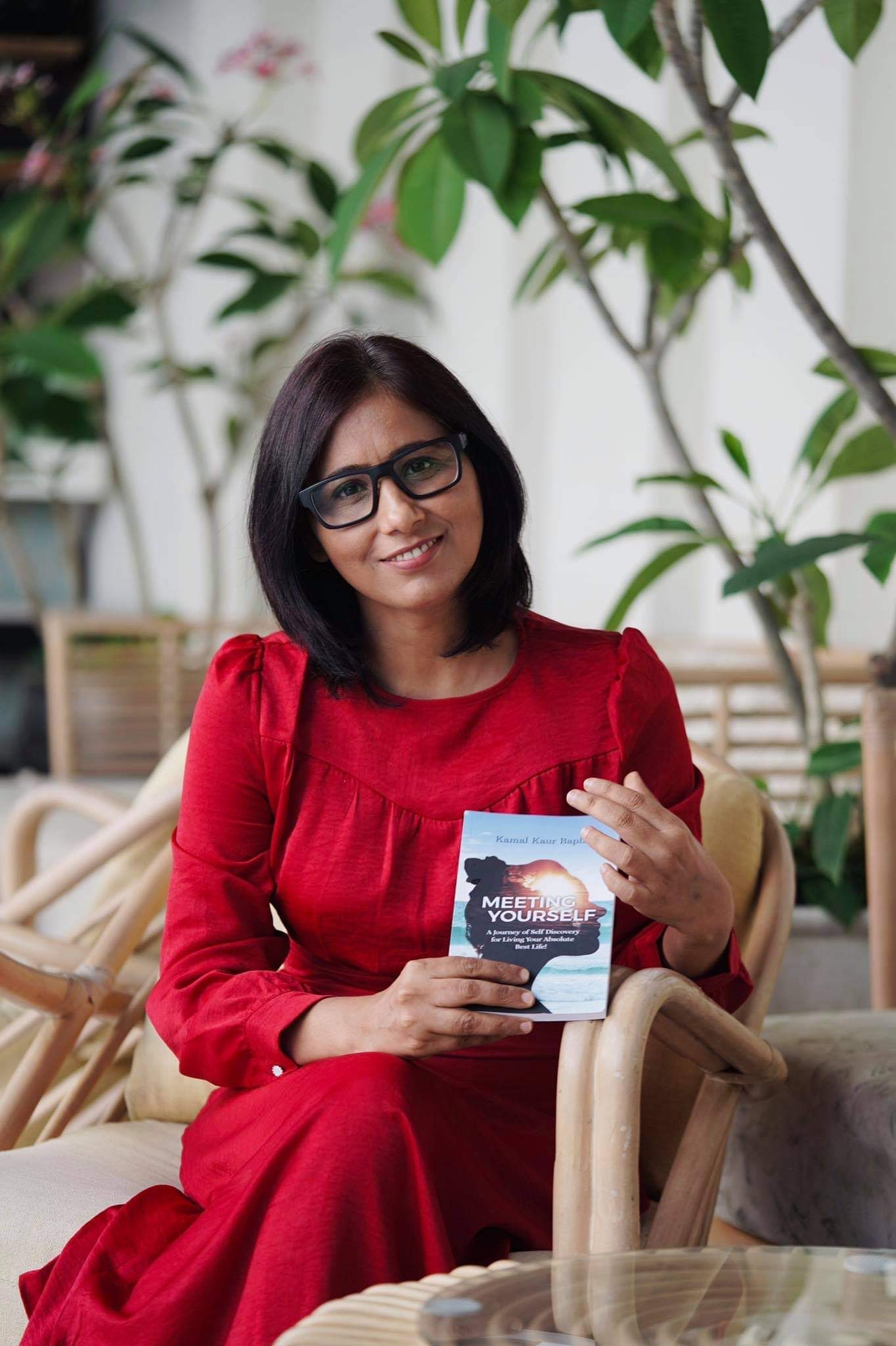 Kamal Bapla holding her book Meeting Yourself