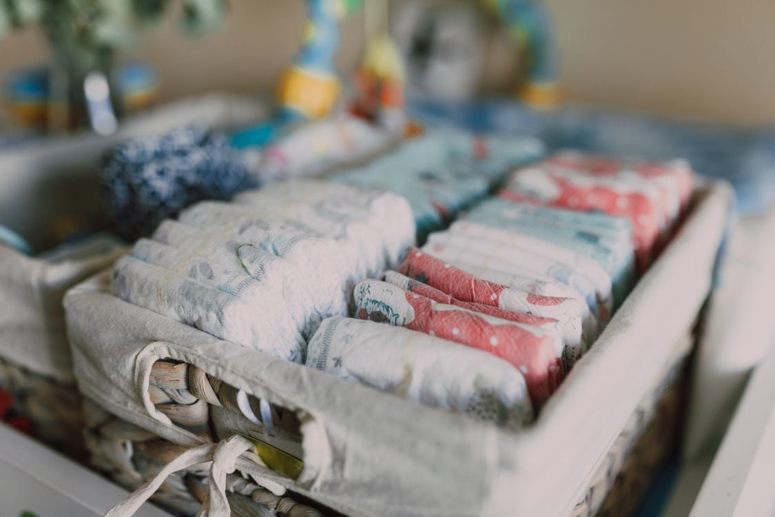 Mother preparing for baby with a notebook and checklist