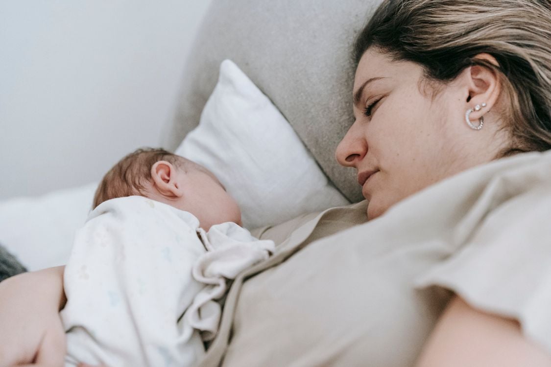Mother holding newborn baby with care