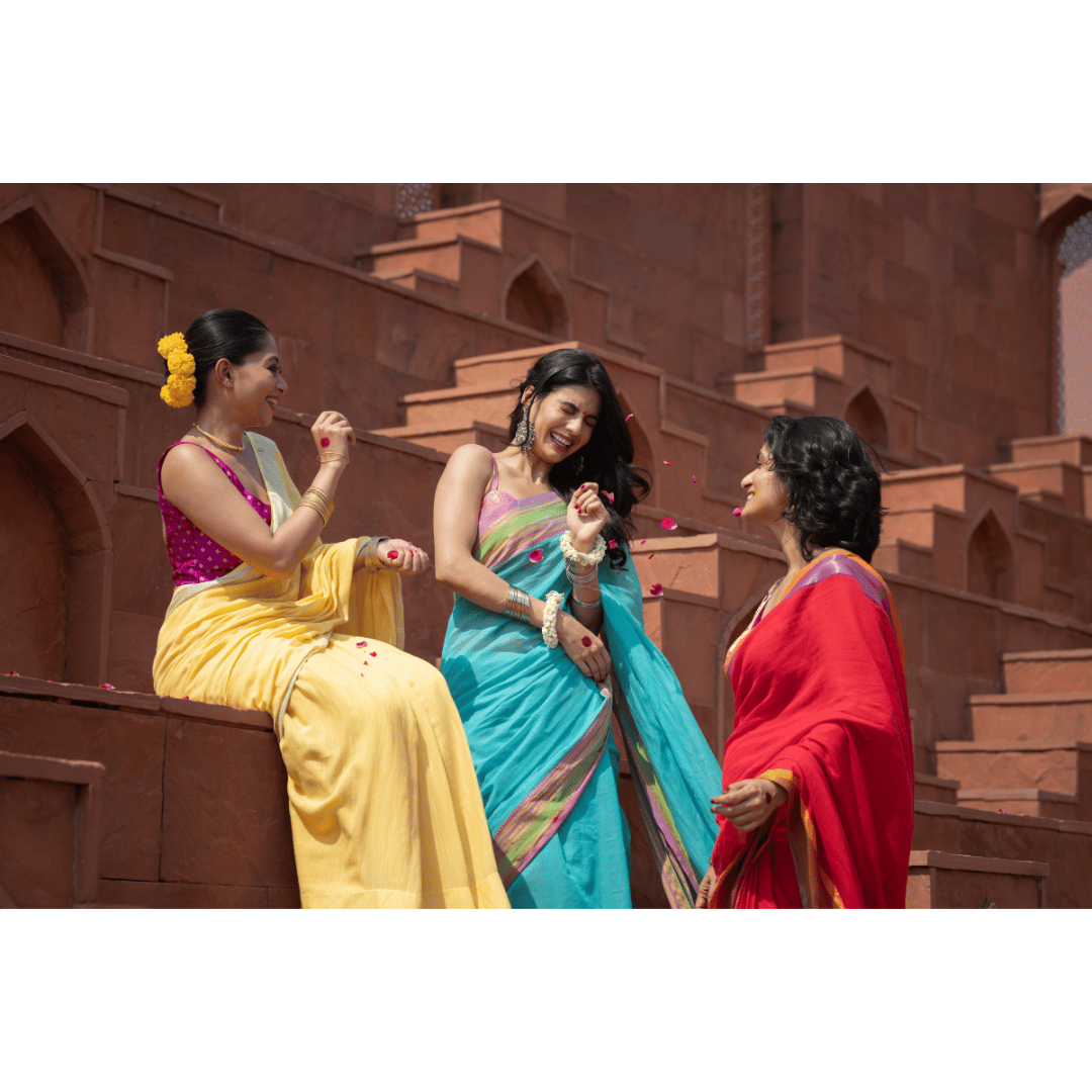 Women laughing together in sarees