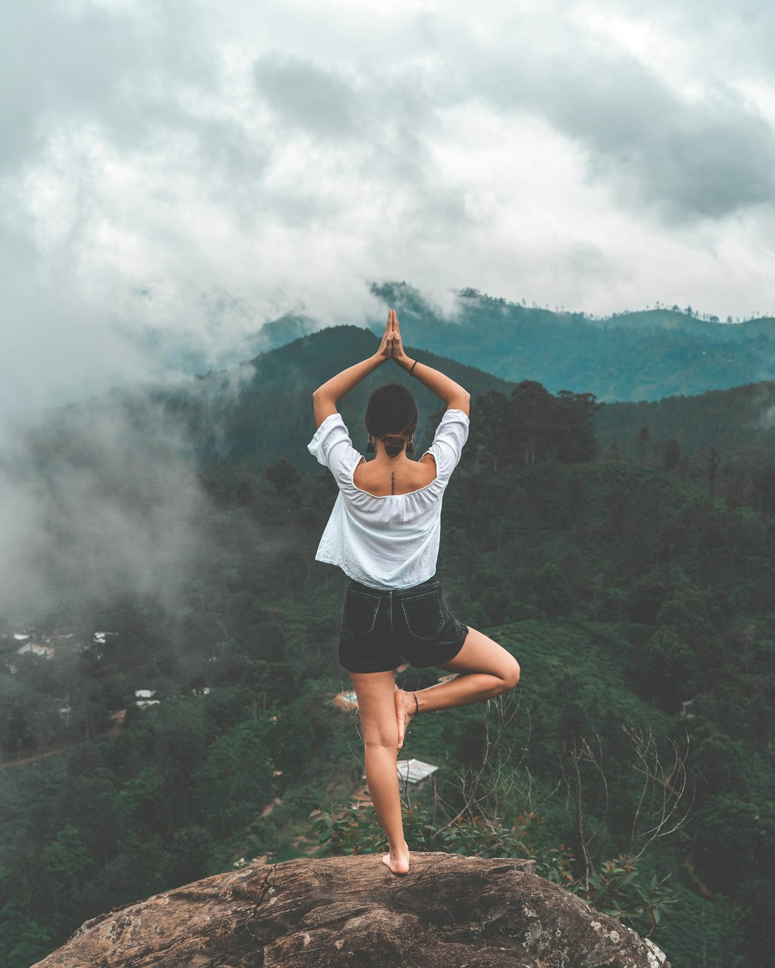 A person practising meditation in a quiet natural setting