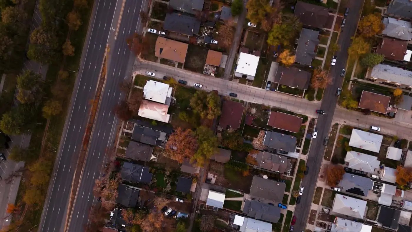 A neighbourhood seen from above: streets, houses and a main road